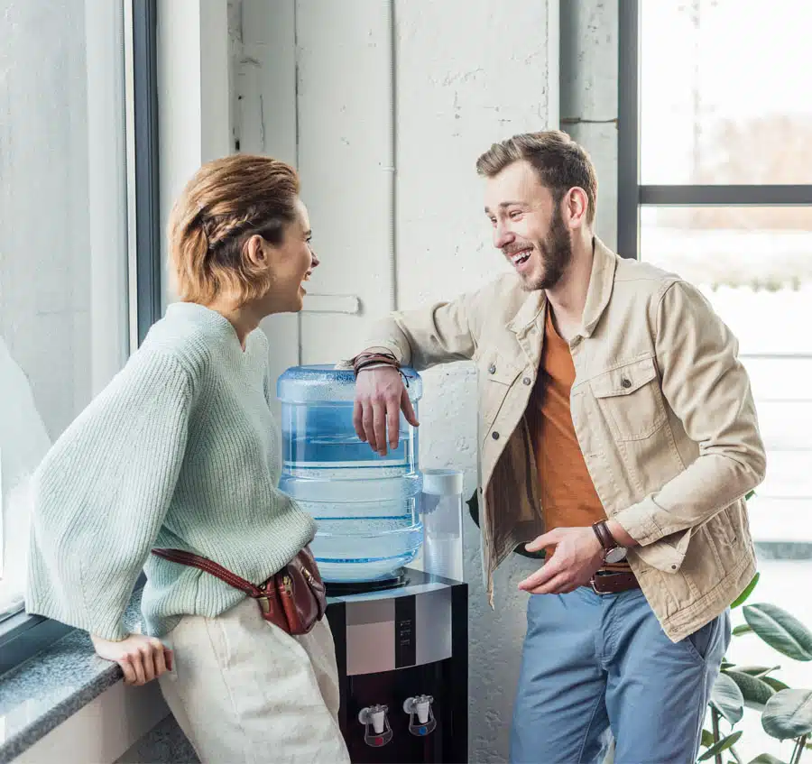 casual businessman and woman talking and laughing in loft office