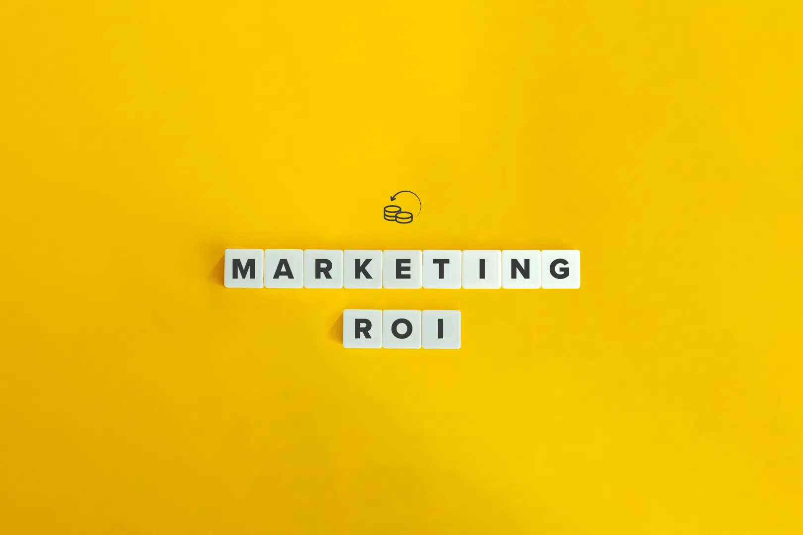 LL MAY 2025 yellow background with the words MARKETING ROI written out with scrabble tiles.