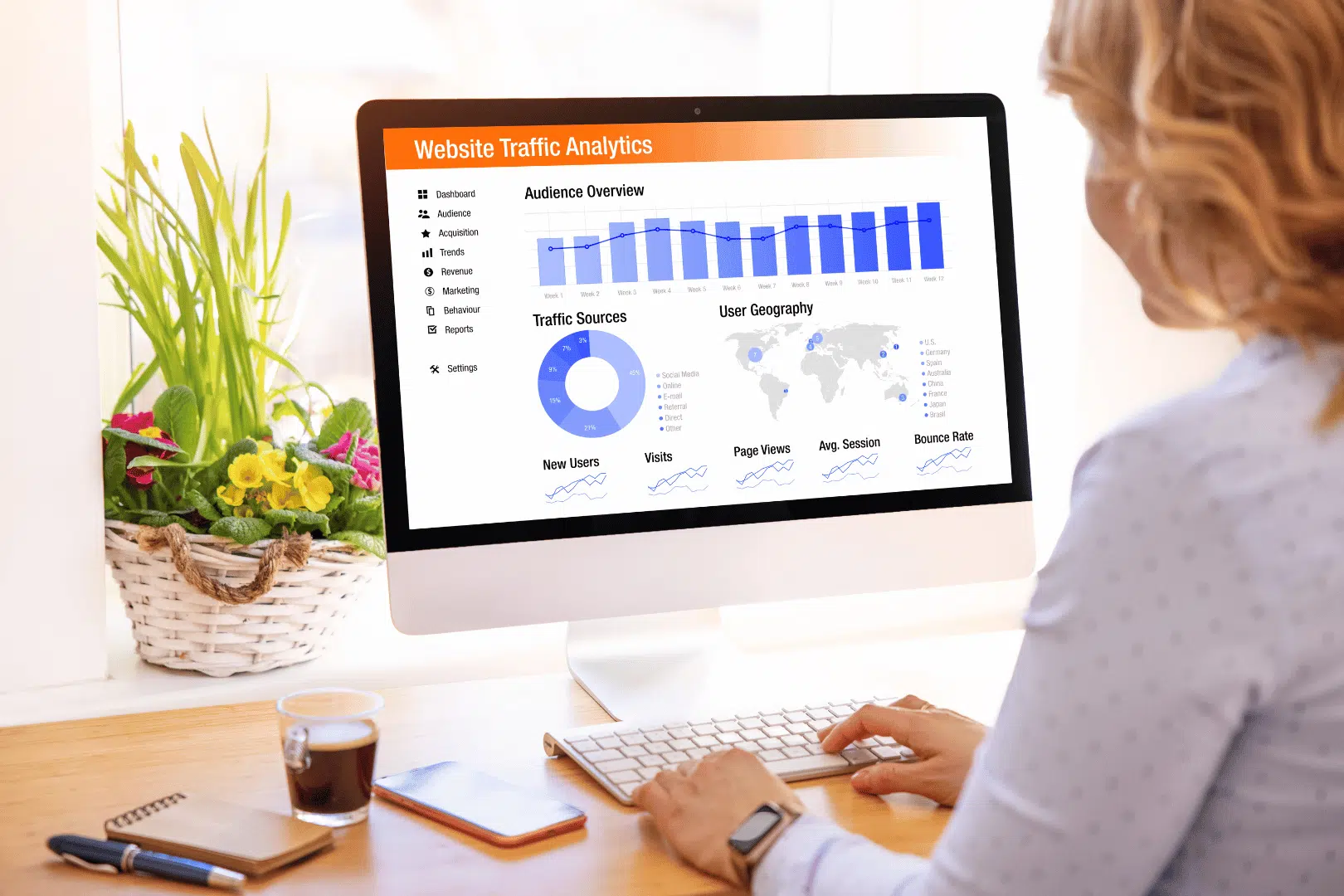 a woman looking at her website analytics on a laptop in a bright room