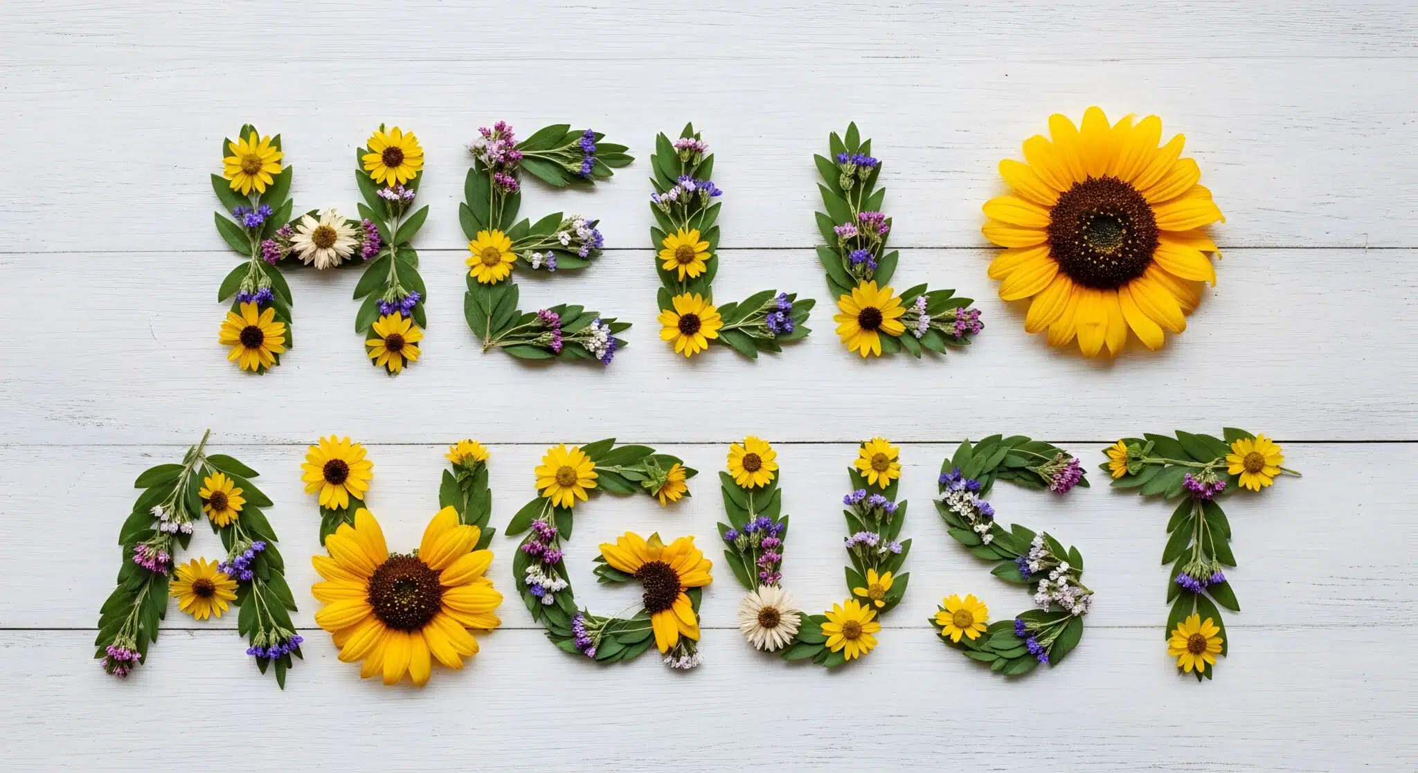 Floral letters spelling ‘HELLO AUGUST’ on a white wooden background with sunflowers and greenery, conveying a warm and welcoming mood